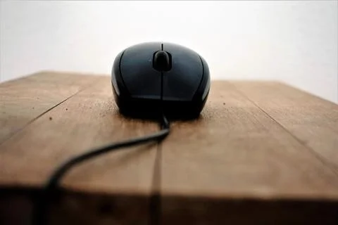 Mouse on wooden table front view Stock Photos