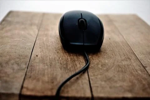 Mouse on wooden table Stock Photos