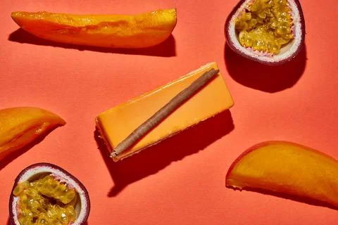 Mousse cake in the composition of passion fruit and mango. Monochrome food .. Stock Photos
