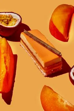 Mousse cake in the composition of passion fruit and mango. Monochrome food .. Stock Photos