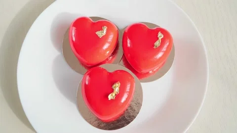 Mousse cake in the form of red hearts. Close-up. Stock Footage 236083280