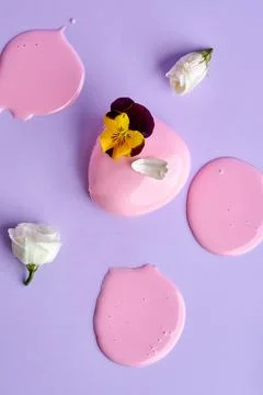 Mousse cake with icing on a pink background. Minimalist composition Stock Photos