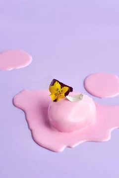 Mousse cake with icing on a pink background. Minimalist composition Stock Photos