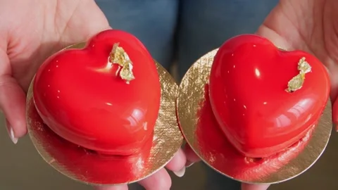 Mousse cakes in the form of two bright red hearts. close-up. Stock Footage 236558696