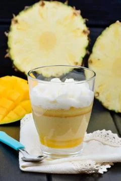 Mousse of mango fruit and pineapple in a glass jar Stock Photos