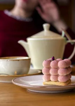 Mousse velor cake on a table in a cafe with a teapot of tea Stock Photos
