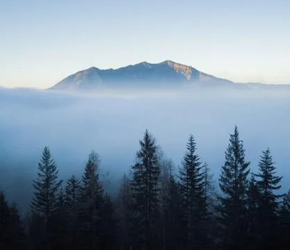 Moutain sits above clouds in Austrian alps Stock Photos