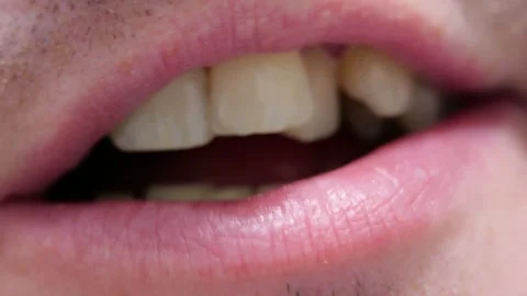 Mouth close up man slowly dissolving throat lozenge moving tongue lightly Stock Footage 320894555