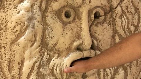 Mouth of truth, Rome, Italy, tourist putting his hand into the ancient mask Stock Footage