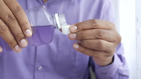 Mouthwash liquid flowing into a cap Stock Footage