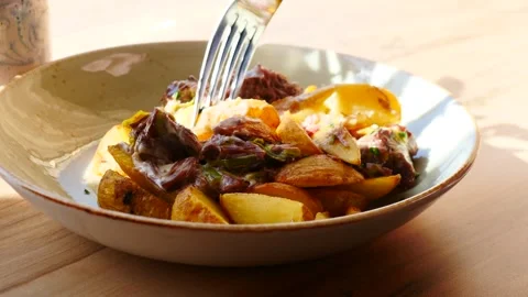 A Mouthwateringly Delicious Dish of Beef and Potatoes Beautifully Served on a Stock Footage 307997668