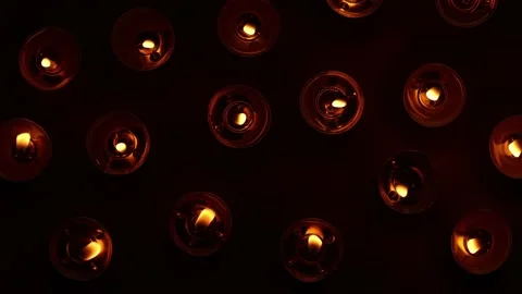 Movable pattern of fire lights from candles on dark background, top view Stock Footage 196540611