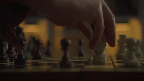 Move after move, a chess player demonstrates his leadership qualities by mov Stock Footage 263594459