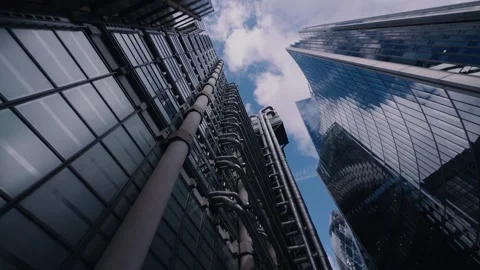 Move between Willis towers Watson and Lloyds showing the gherkin blue skies Stock Footage 297249239