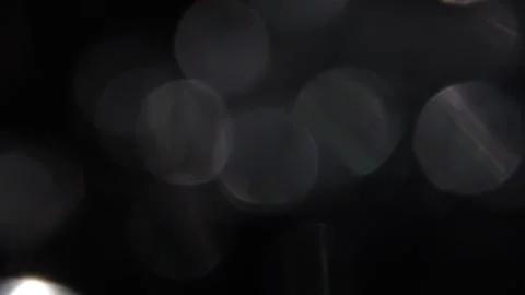 Move the bokeh to the left. Cover the white bokeh light leak on the black backgr Stock Footage 317455169