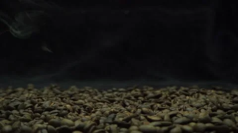 Move the camera slowly from  right to left .hot roasted coffee beans with so Stock Footage 182472587