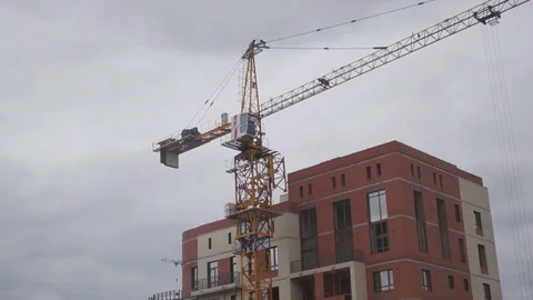 Move the construction crane on a construction site against a cloud background Stock Footage 80859482