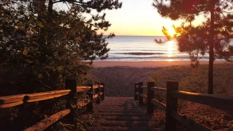 Move down stairway to beach and sunrise Stock Footage 100134826
