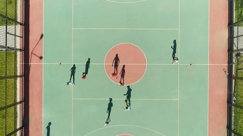 Move drone shadow children playing football green stadium sunny day with 4K. Stock Footage 121487121