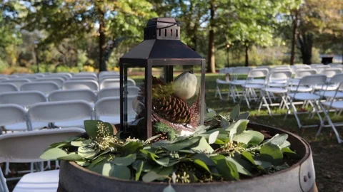 Move in on lantern holding pine cones on barrel Stock Footage 96547763