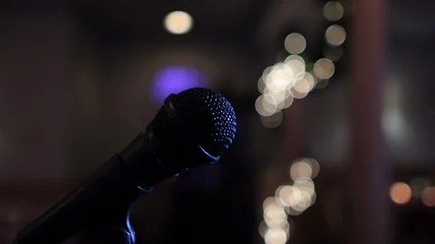 Move in on microphone head creating large bokeh lights Stock Footage 96547843