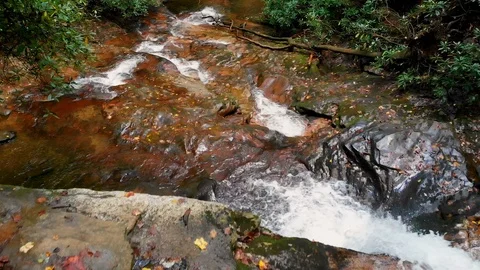 Move Over Edge of Waterfall Down Over Creek Stock Footage 96753861