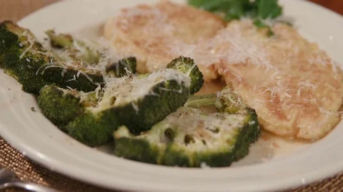 Move Toward Over Chicken and Broccoli Dish Close Up on Brown Mat Stock Footage 81276830