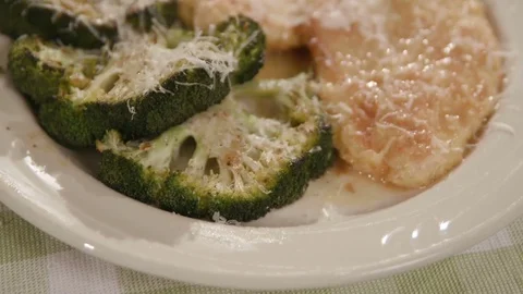 Move Toward Over Chicken and Broccoli Dish Close Up on Green Mat Stock Footage 81276924