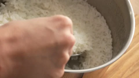 Move white rice from pan to a plate. Stock Footage 253560770