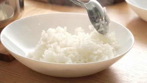Move white rice from pan to a plate. Stock Footage 253560790