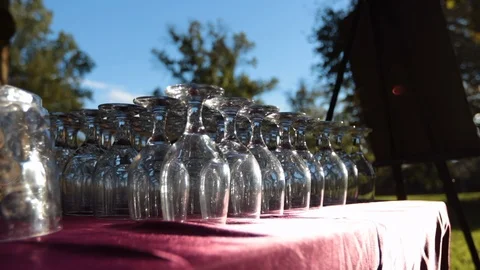 Move in on wine glasses outside on red table cloth sun shining Video stock 96547940