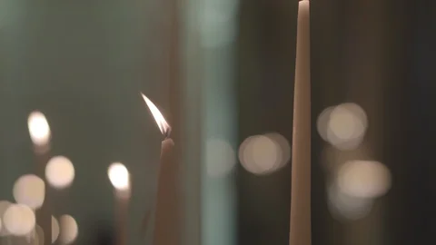 The movement along the burning candles on the background of light flare. Bokeh Stock Footage 128429364