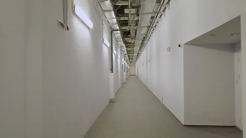 Movement Along an Empty Corridor in an Office Building. Shooting with Stabilizer Stock Footage 104002825