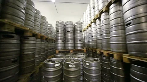 Movement along high rows of metal beer kegs in warehouse Stock Footage 37656712