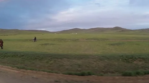 Movement Along Road in Steppe Past Standing People Stock Footage 62570655
