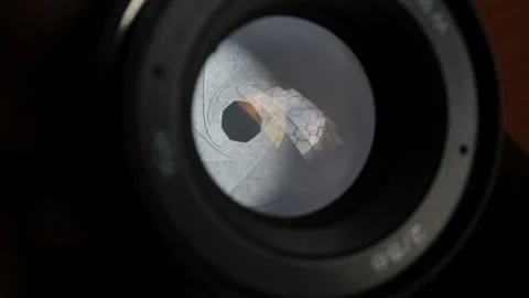 A movement of the aperture flaps on the camera lens. Aperture photo lens close Stock Footage 139917790