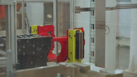 Movement of an automobile engine on an assembly line Stock Footage 318528099