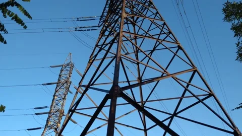 Movement from the base to the top of the high-voltage power tower.  B roll Stock Footage 161945173