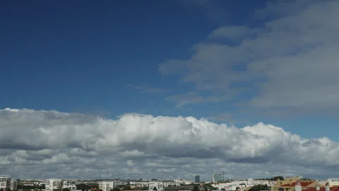 Movement of beautiful clouds in the blue sky over city houses. Stock Footage 251878974