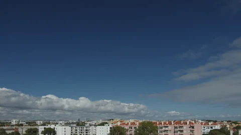 Movement of beautiful clouds in the blue sky over city houses. Stock Footage 251879092