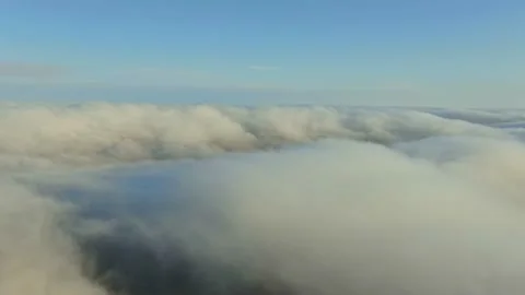 Movement between a dense layer of white clouds and a clear blue sky 스톡 동영상 131552661