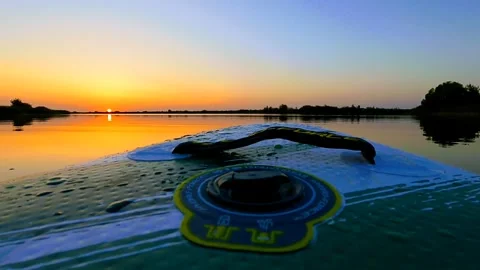 Movement on a board on the water surface to the sun Stock Footage 251961923