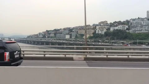 Movement on bridge over the river, high traffic. Big city life. View of a Stock Footage 81857286