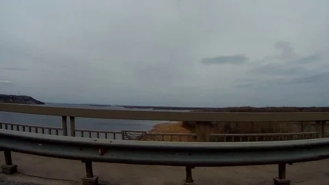 Movement on the bridge overlooking the river and the sky Stock Footage 75897605