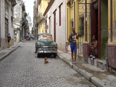 Movement by broken old green retro car is parked on road pavement side in Stock Footage 70857388