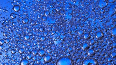 The movement of bubbles in the liquid blue Stock Footage 84764946