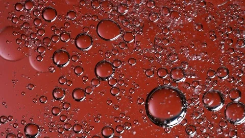 The movement of bubbles in a liquid of red color Stock Footage 84762049