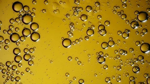The movement of bubbles in liquid yellow Stock Footage 84754790