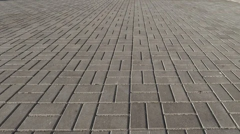 Movement of the camera along the paving slabs of gray, rectangular shape Stock Footage 126354382