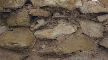 Movement of the camera along the wall of natural stone, the fence Stock Footage 86043620